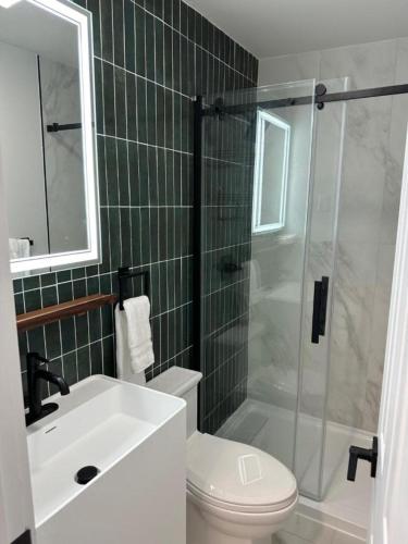 a bathroom with a sink and a toilet and a shower at Chalet 239-Boutique Hotel in West Dover