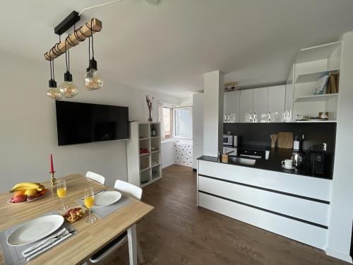 a kitchen with a table with plates on it at Sunny Alps View: Central Bliss in Grächen