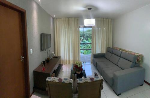 a living room with a couch and a table at Vários Apartamentos no villas maceio in Maceió