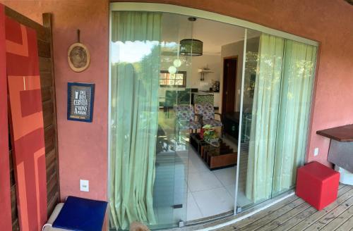 a living room with a sliding glass door at Vários Apartamentos no villas maceio in Maceió