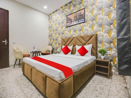 ein Schlafzimmer mit einem großen Bett mit roten Kissen in der Unterkunft Super OYO Silver Sky in Ludhiana