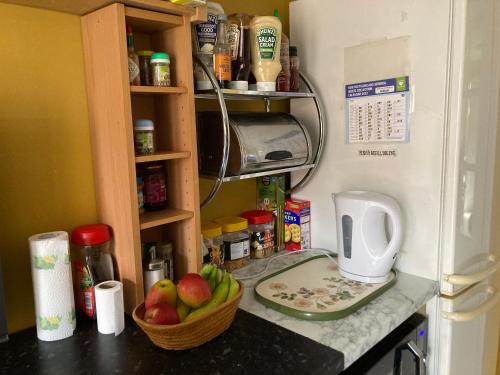 a kitchen counter with a toaster and a bowl of fruit at B4-Jacks Court in Stalybridge