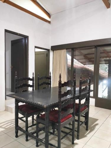 a dining table and chairs in a room at Villa sagitarius in Bogor
