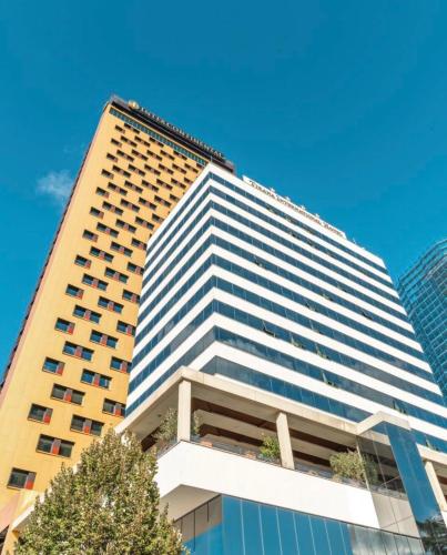 a tall building with windows on the side of it at Tirana International Hotel & Conference Center in Tirana