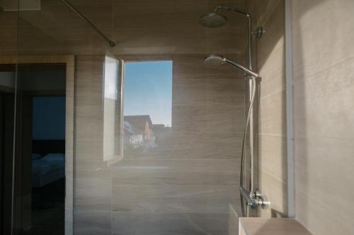 a shower with a glass door in a bathroom at Ionesco Apartments in Cluj-Napoca