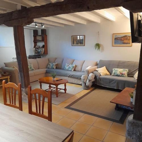a living room with a couch and a table at El Callejo de Abiada in Abiada