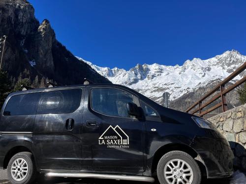 a black van parked in front of a mountain at Maison La Saxe in Courmayeur