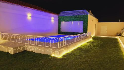 une maison avec des lumières violettes latérales dans l'établissement شـاليــه غـيــم, à Riyad