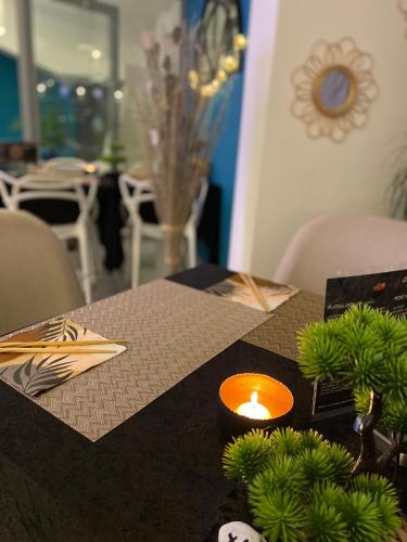 a table with a candle on top of a table at Hotel La Voile in Bormes-les-Mimosas