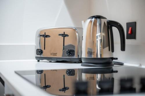 two toasters sitting on top of a kitchen counter at 2 Double Beds - 2 Single Beds in Manchester