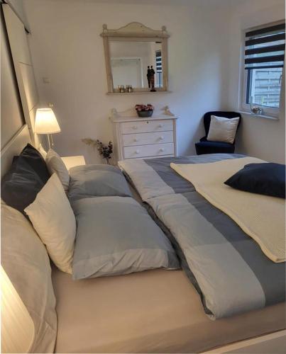 a bedroom with two beds and a dresser with a mirror at Aufatmen in Ahlbeck in Ahlbeck