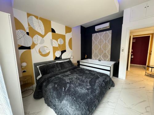 a bedroom with a large black bed in a room at Cagliari Love Suite in Cagliari
