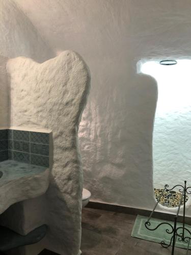 a bathroom with a sink and a bath tub at Cueva Aventura in Benamaurel