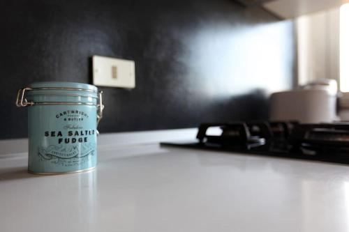 a jar of tea sitting on top of a counter at HACCA Collection - Isola 1BR in Milan