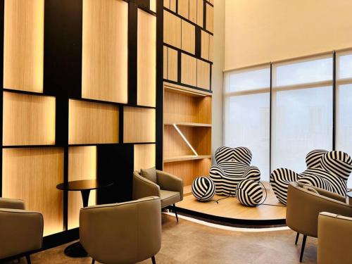 a room with chairs and a table and a window at New Urban Suite Majestics 3BR Homestay at Georgetown BY URBAN STAYCATION HENG LOD in Jelutong