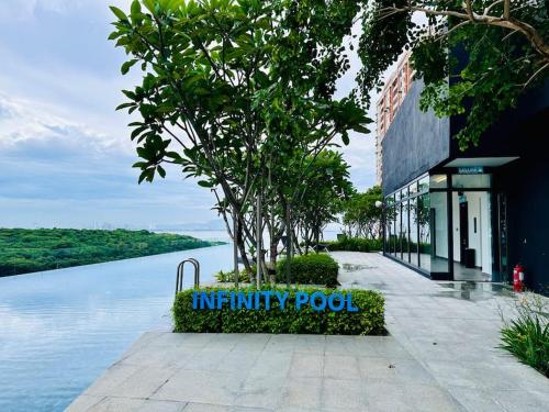 a sign in front of a building next to a body of water at New Urban Suite Majestics 3BR Homestay at Georgetown BY URBAN STAYCATION HENG LOD in Jelutong