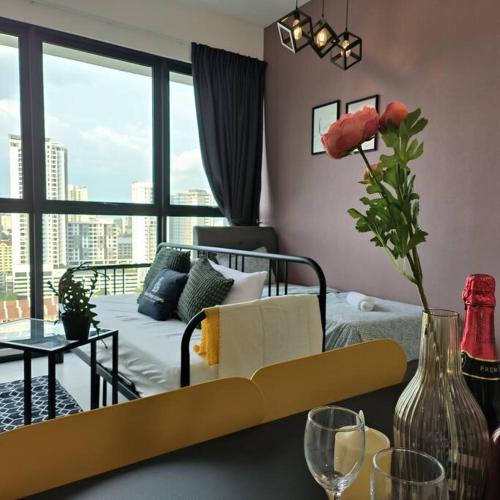a living room with a couch and a table with wine glasses at New Urban Suite Majestics 3BR Homestay at Georgetown BY URBAN STAYCATION HENG LOD in Jelutong