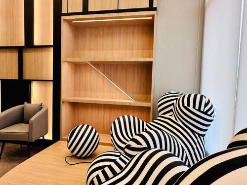 a room with two chairs and a table at New Urban Suite Majestics 3BR Homestay at Georgetown BY URBAN STAYCATION HENG LOD in Jelutong