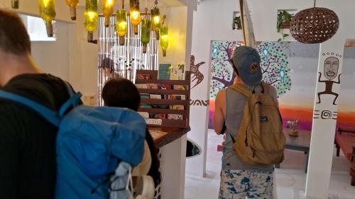 a group of people standing in a store at Casa Oro Eco Hostel in San Juan del Sur