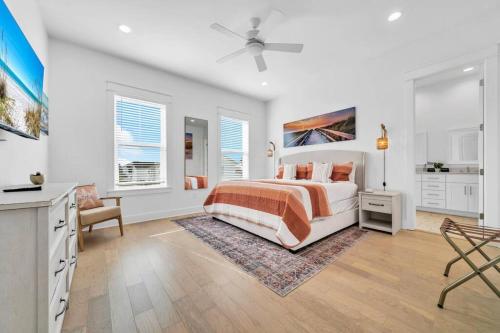 a white bedroom with a bed and a table and chairs at Spacious home 1/2 mile to beach - Bikes - Fire Pit Table - Beach Gear - Infinity Table in Inlet Beach