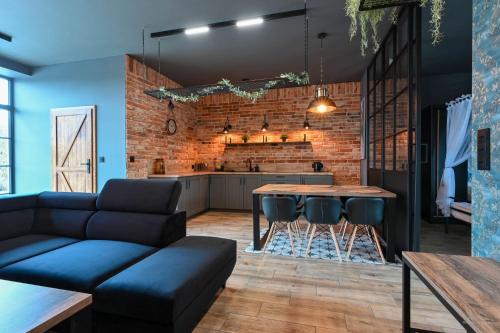 a living room with a couch and a table at Aparthotel Mamma Mia - Oświęcim in Oświęcim