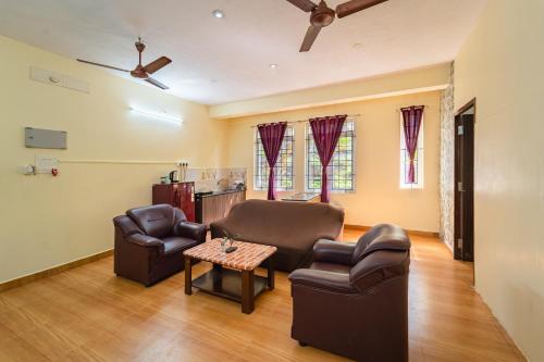a living room with two chairs and a table at Le Mission Stay in Puducherry