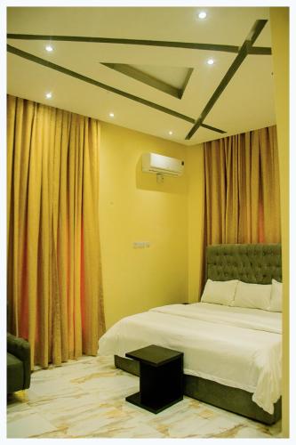 a bedroom with a bed and curtains and a bedvisor at House 7A in Enugu