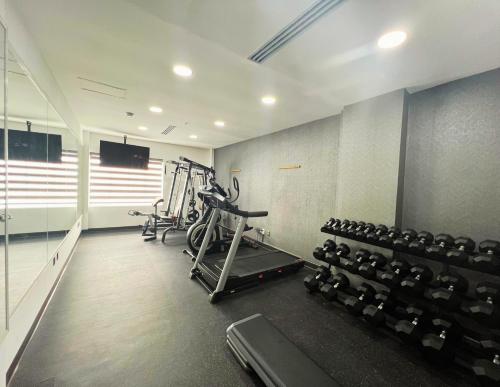 a gym with treadmills and machines in a room at La Quinta by Wyndham Reynosa in Reynosa