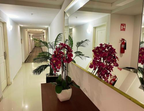 a hallway with potted plants in a building at La Quinta by Wyndham Reynosa in Reynosa