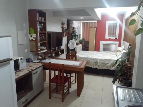 una camera con cucina e una camera con letto di Loft conceito aberto - 4 pessoas a Araranguá