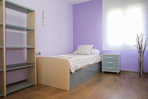 a bedroom with a bed and a book shelf at L Estel del Riu in La Cava