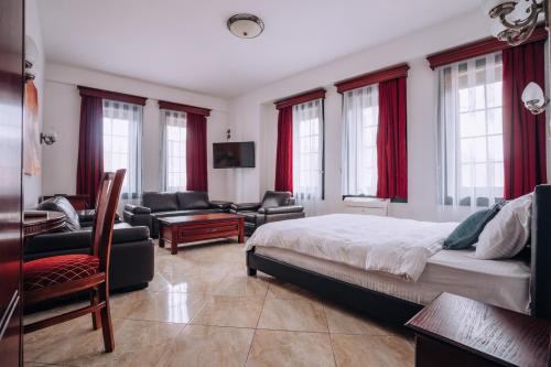 a bedroom with a bed and a living room at Lihnidos Square in Ohrid