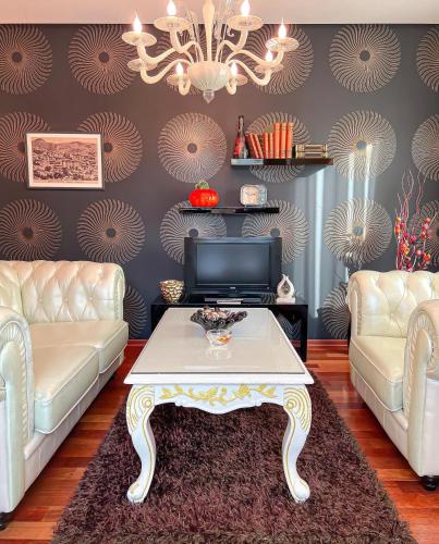 a living room with two couches and a coffee table at Tirana International Hotel & Conference Center in Tirana