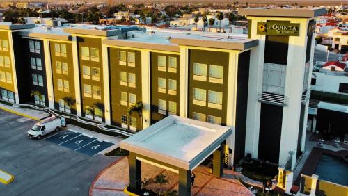 an overhead view of a yellow building with a street at La Quinta by Wyndham Reynosa in Reynosa