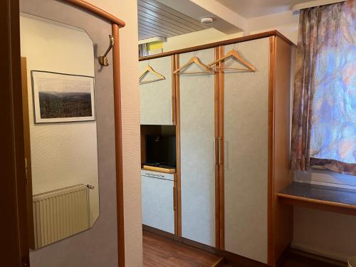 a room with a door to a kitchen with a television at Landgasthaus waldhorn in Forbach