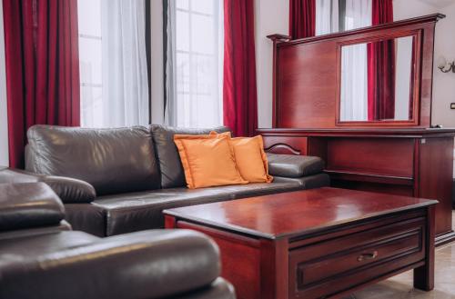 a living room with a leather couch and a table at Lihnidos Square in Ohrid