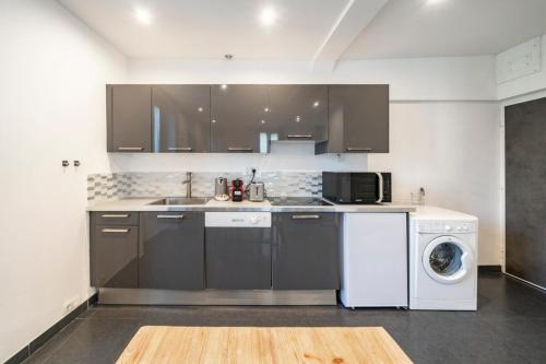 une cuisine avec un évier et une machine à laver dans l'établissement Nice studio in the heart of Cannes, à Cannes