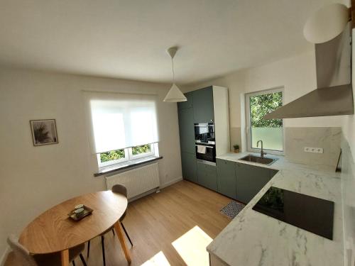 a kitchen with a table and a counter top at Comfort apartment in Warsaw