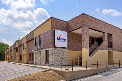 a building with a sign on the side of it at Suburban Studios Raleigh - Crabtree Valley in Raleigh