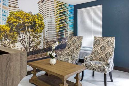 a living room with a table and two chairs at Suburban Studios Raleigh - Crabtree Valley in Raleigh