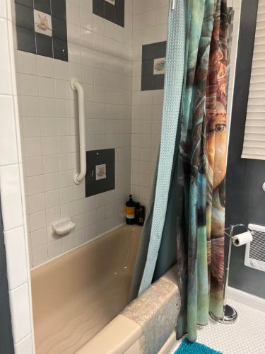 a bathroom with a bath tub with a shower curtain at Mermaid's Muse Bed and Breakfast in Brookings