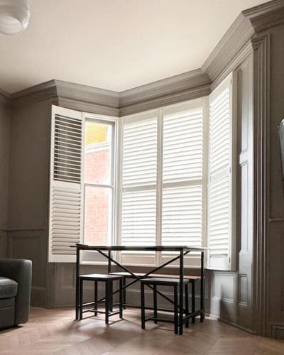 a room with a table in front of a window at Luxury Apartment, Old Town - Hastings in Hastings