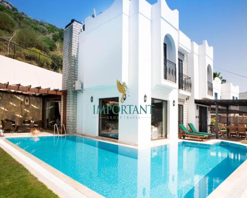 a swimming pool in front of a villa at Villa Rana by Important Group Travel in Yalıkavak