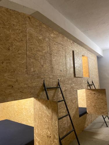 a room with a stone wall and a ladder at FOX BOX II Capsule Apt in Dresden
