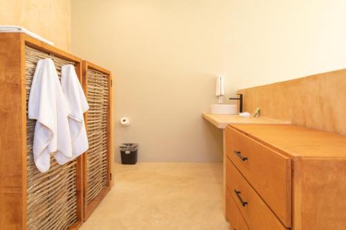 a bathroom with a sink and a towel rack at Cerritos Surf Town - Beach Front Property in El Pescadero