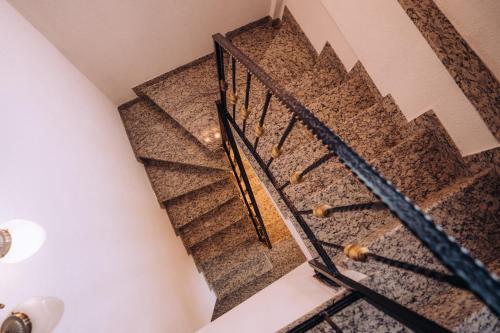 a staircase in a house with black railings at Lihnidos Square in Ohrid
