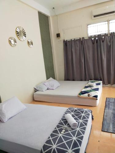 Кровать или кровати в номере Vakantie Syariah Guesthouse
