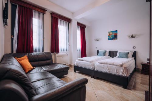a living room with a couch and a bed at Lihnidos Square in Ohrid