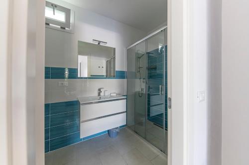 a bathroom with a sink and a shower at ***Villa Prestige**** in Capoliveri