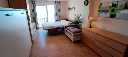 a small room with a bed and a window at ESTUDIO DELANTE DEL MAR in Adra